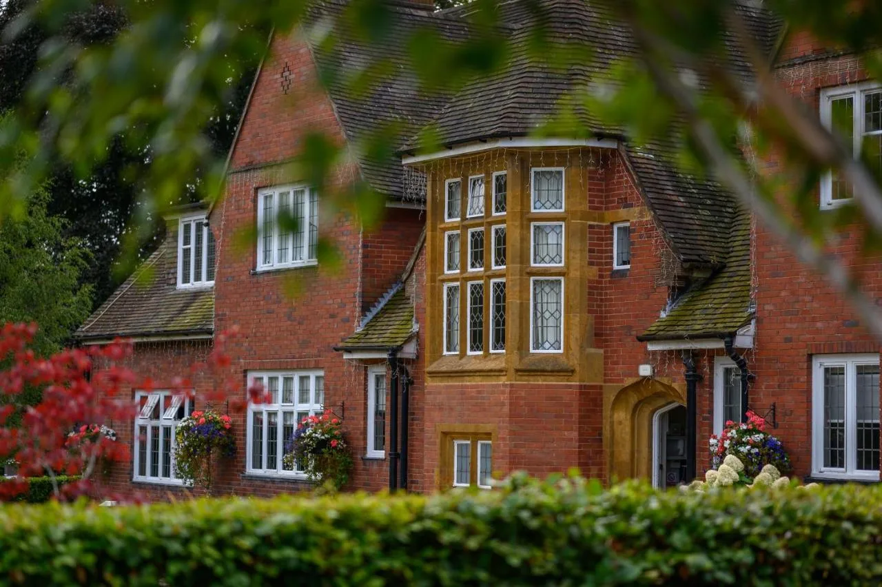 a large red brick house with white windows at Edgbaston Park Hotel Birmingham in Birmingham