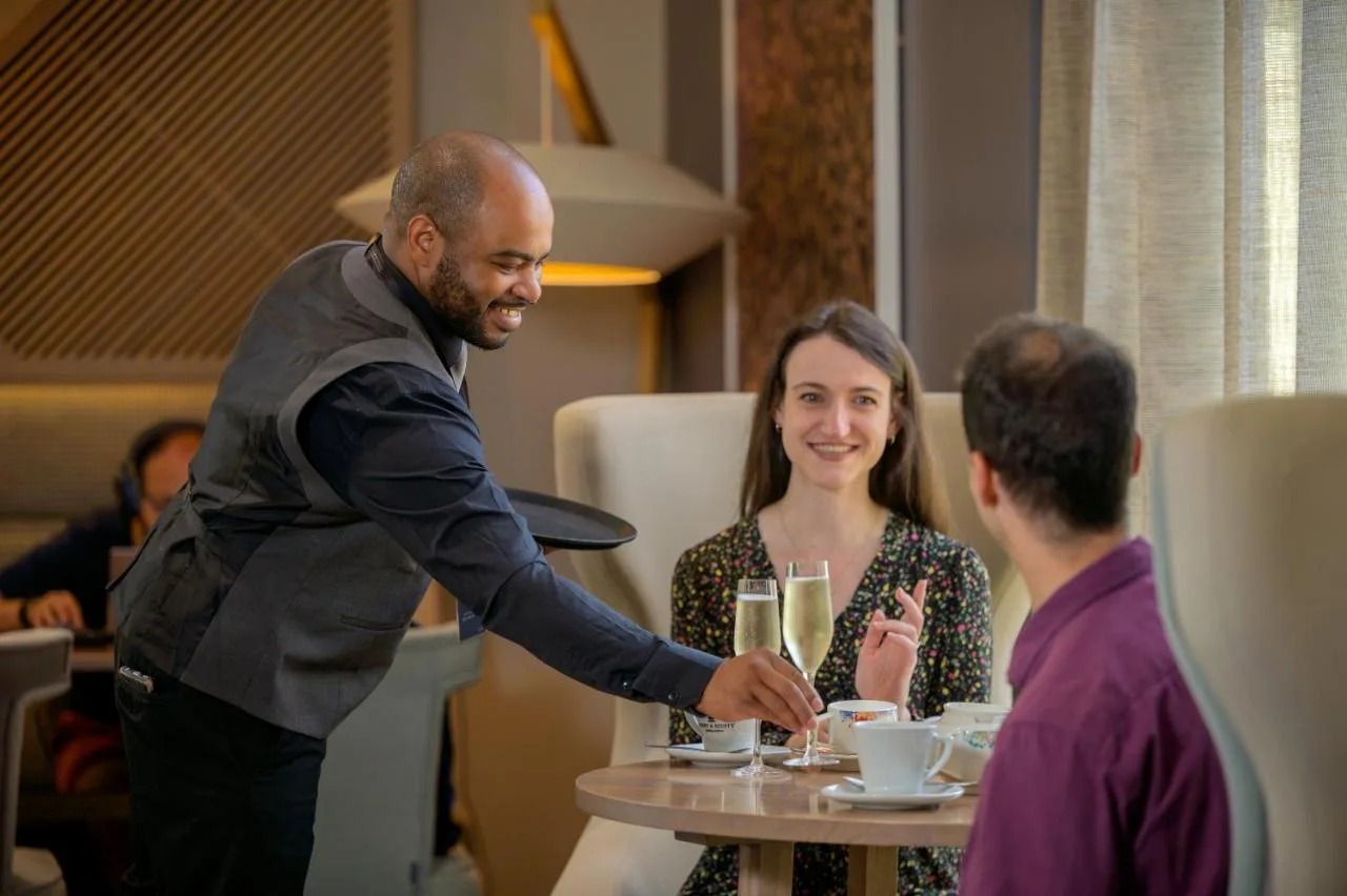 a man shaking hands with a woman at a table at Edgbaston Park Hotel Birmingham in Birmingham
